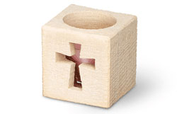Carved limestone votive holder with cross design.